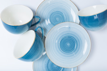 Clean dishes, coffee or tea set. Plenty of elegant porcelain cups and saucers at white background