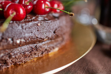Side of a chocolate frosting cherry layer cake