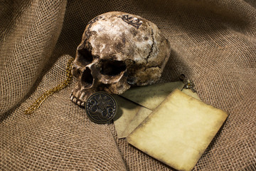 Damaged skull with a letter, with a burlap background