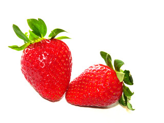 Red strawberries with green leaves isolated on white background.
