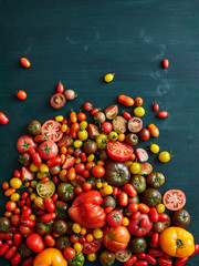 Selection of tomatoes on a wooden surface