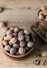 Walnuts on rustic wooden background. Food, nuts background. Print for kitchen