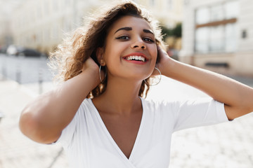 Half length portrait of beautiful young girl with brunette curly girl