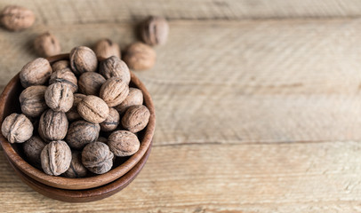 Walnuts on rustic wooden background. Food, nuts background. Print for kitchen
