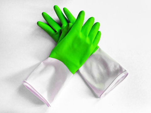 pair of rubber green gloves for cleaning isolated on white background. Closeup top view. General or regular cleanup. Commercial cleaning company concept.
