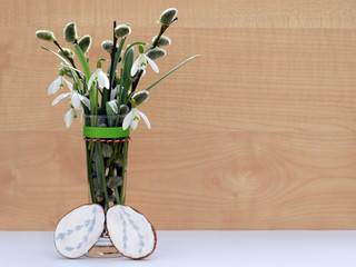 Spring composition with snowdrops, willow twigs and gingerbread eggs