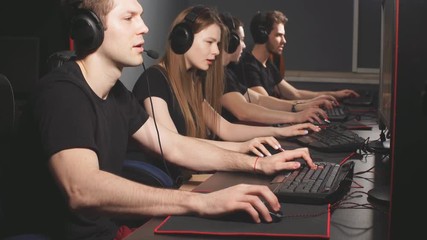 Casual gamers and hardcore fans are gather together in pc gaming club to compete in playing MMO Games online Tournament