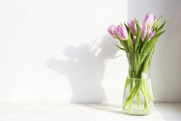 Multy purpose fresh flower composition, bouquet of purple tulips. International Women's day, mother's day greeting concept. Copy space, close up, top view, flat lay, background.