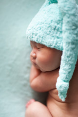 newborn baby asian boy sleeping at blue background