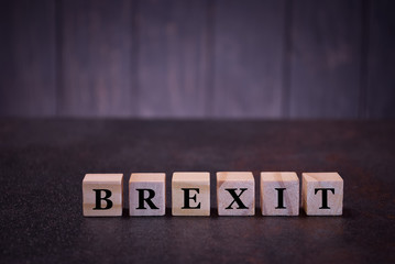 Obraz premium The word brexit on wooden cubes, light wooden cubes signs