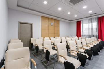 Empty modern conference hall in new hotel. Room for training, education, group classes, exams. Audience for Speakers at Business convention and Presentation.