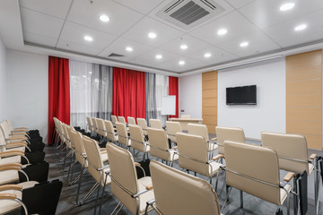 Empty modern conference hall in new hotel. Room for training, education, group classes, exams. Audience for Speakers at Business convention and Presentation.