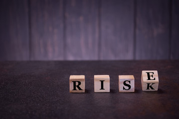 The word rise risk on wooden cubes, light wooden cubes signs