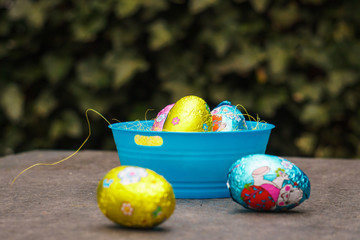 easter eggs in basket on a stone table