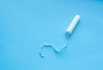 Menstrual period concept. Woman hygiene protection. Cotton tampons on blue background
