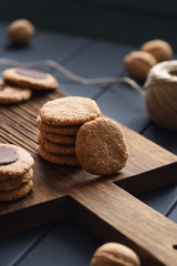Yummy vegan dessert. Peanut butter, oats and almond cookies with chocolate drops on dark oak board