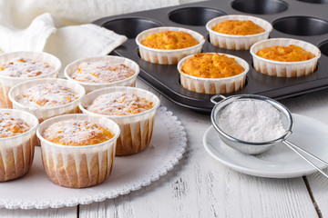 sweet pumpkin muffins with walnuts and powdered sugar