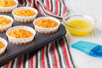 Making of homemade pumpkin muffins, in a baking pan