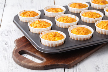 Making of homemade pumpkin muffins, in a baking pan
