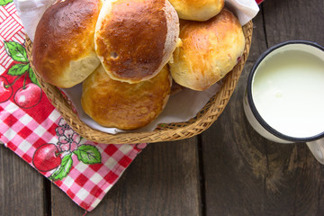 Traditional russian pastry - piroshki on wooden table.