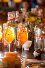 female bartender preparing aperol  cocktail in a cocktail bar