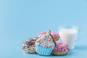 Donuts on a blue with a cup of milk