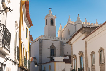 Fototapeta na wymiar The view of street of Evora with the cozy white and yellow houses. Evora. Alentejo. Portugal