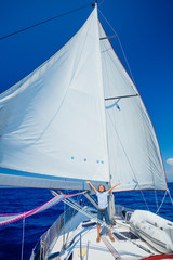 Little boy on board of sailing yacht on summer cruise. Travel adventure, yachting with child on family vacation.