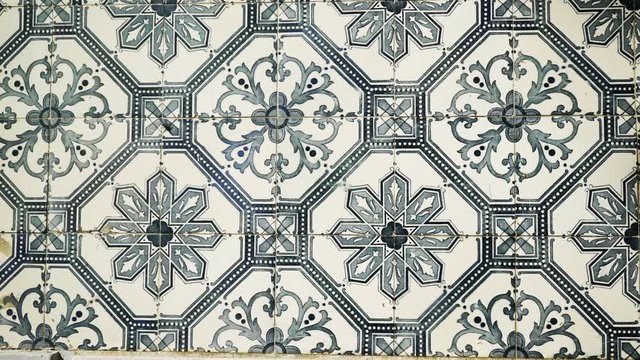 Closeup Azulejo painted, traditional portugal art work abstract green pattern tin-glazed ceramic tile work on walls in Lisbon
