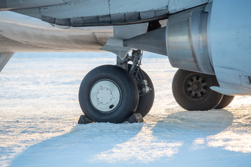 chassis airplane close-up in winter in snow. Close-up of chassis of passenger airliner in the snow...