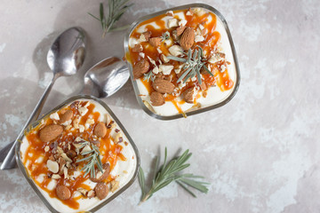 Dessert bowl with tasty caramel parfait on table.