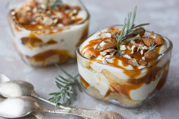 Dessert bowl with tasty caramel parfait on table.