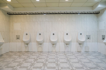 public men's toilet with wall urinals and closed cabins, men's wall urinals