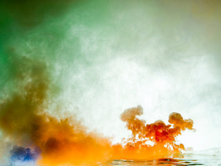 mixing color paints in water, abstract background
