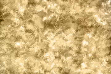 Golden powder explosion on black background. Freeze motion.