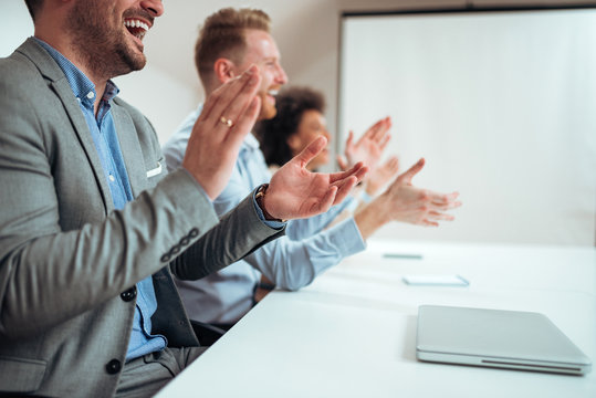 Close-up image of businesspeople clapping hands after business seminar or presentation.