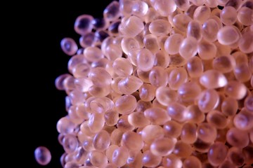 pink small silicone balls on a black background