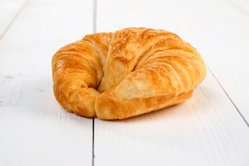 fresh baked croissant on wooden table