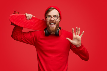Fototapeta premium Hipster with skateboard waving hand