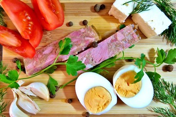 Tasty snack with tomato, jelly, garlic, feta, boiled egg and greens