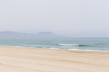 perspective sandy beach and sea coastline cloudy sky mountains in the background Rethymno Crete
