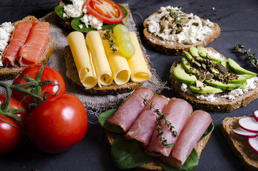 sandwiches with various fillings: ham, cheese, avocado, sauce