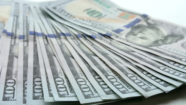 Panning shot over US 100-dollar bills