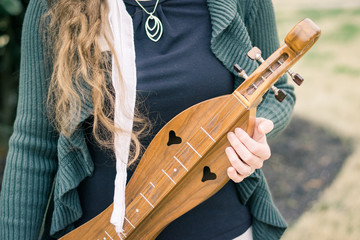Girl Holding a Mountain Dulcimer