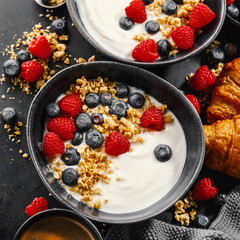 Yogurt with berries and granola in bowl