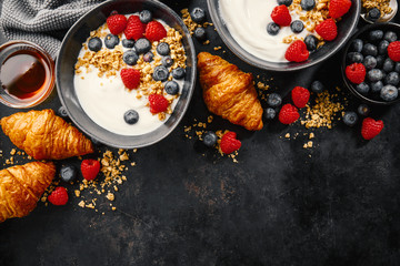 Yogurt with berries and granola in bowl