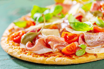 Appetizing italian pizza with prosciutto
