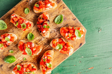 Classic italian bruschetta served on wooden board