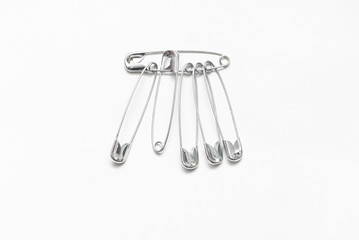 safety pin on white background,  with space for text