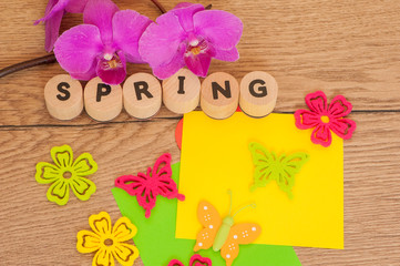Spring - letters and flowers decoration on wood 
